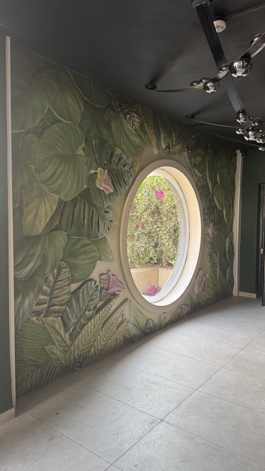 Artistic Botanical Basalt Relief Around Circular Window by MarbleVeins.