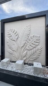 CNC-carved botanical bas-relief in natural beige stone by MarbleVeins in Jordan.